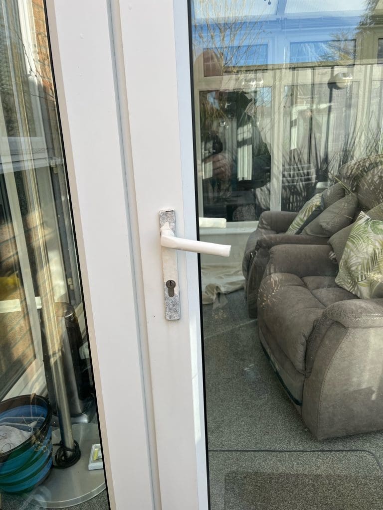 Close-up of a broken UPVC French door lock in Swindon – urgent repair needed to restore security.