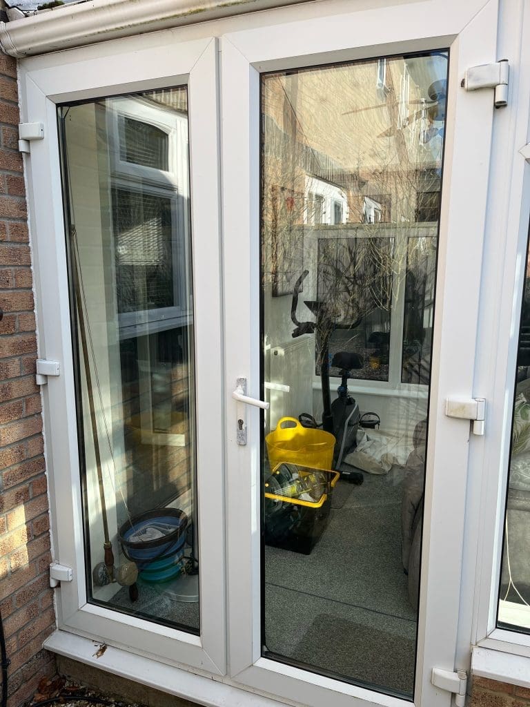 UPVC French door with a broken handle and faulty lock in Swindon – requiring repair and security enhancement.