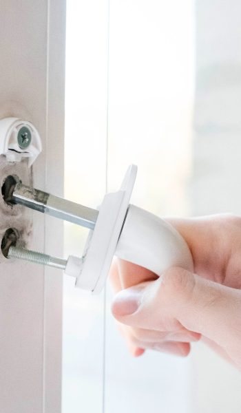 The window handle cracked. The man holds it in his hand, the iron pins are visible.